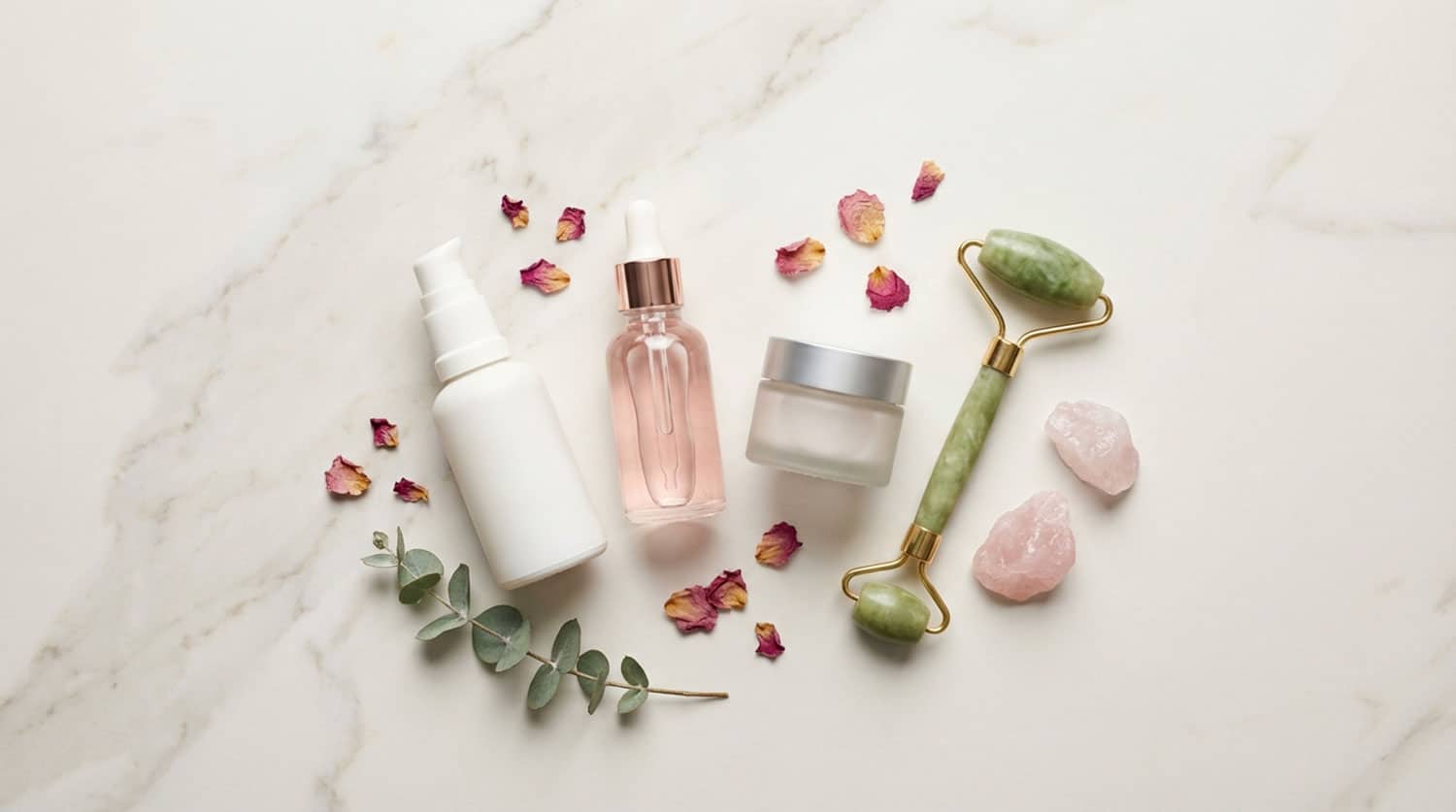 Skincare products and rose petals